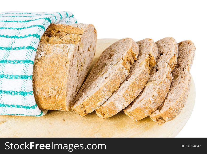 A loaf of fresh bread wrapped up in a tea towel