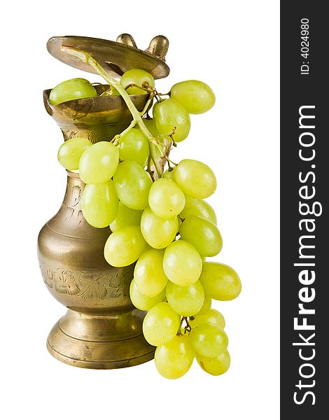 A copper pot with grapes on a white background