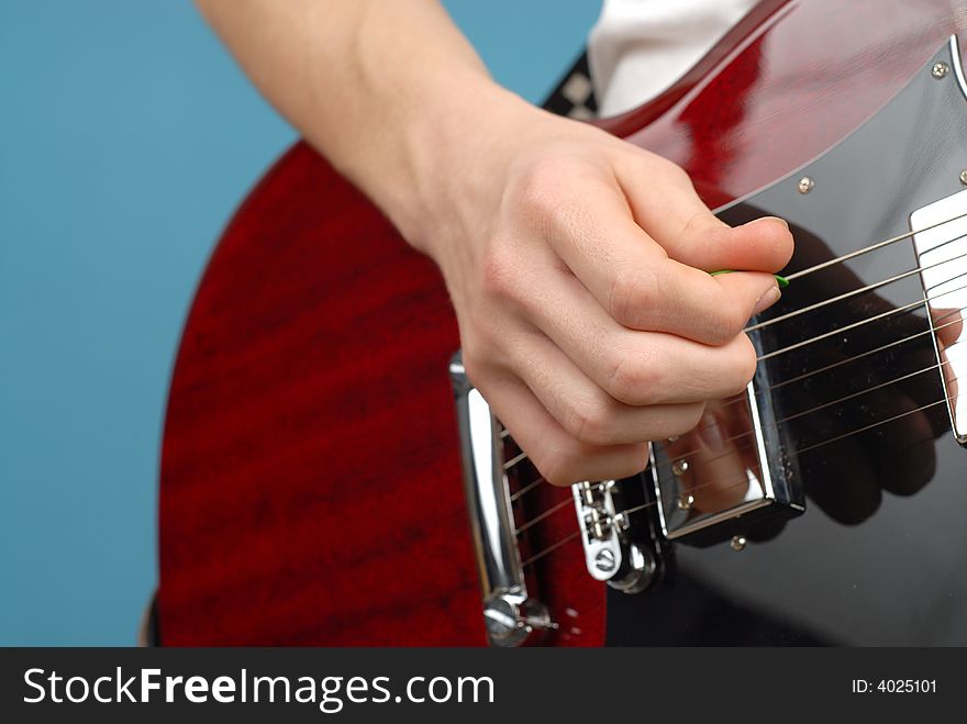 Simple shot of a teenager's hand playing a guitar; copy space can easily be extended. Simple shot of a teenager's hand playing a guitar; copy space can easily be extended