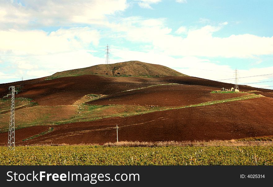 Cloudy autumnal sky and country. Beautiful autumn country landscape.  cultivated land, hills,  blue sky & clouds. Sicily, Italy. Cloudy autumnal sky and country. Beautiful autumn country landscape.  cultivated land, hills,  blue sky & clouds. Sicily, Italy