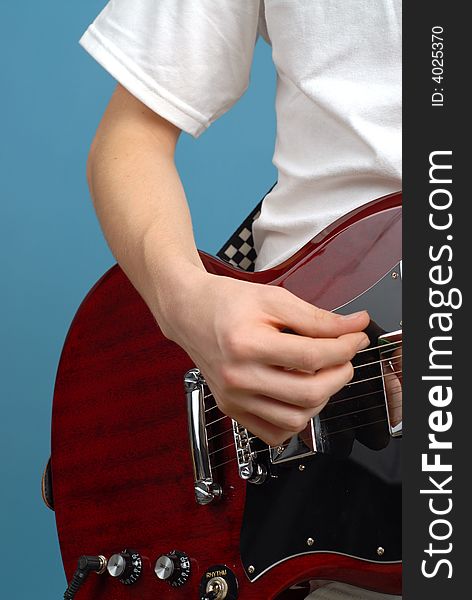 Vertical detail shot of an electric guitar player. Vertical detail shot of an electric guitar player