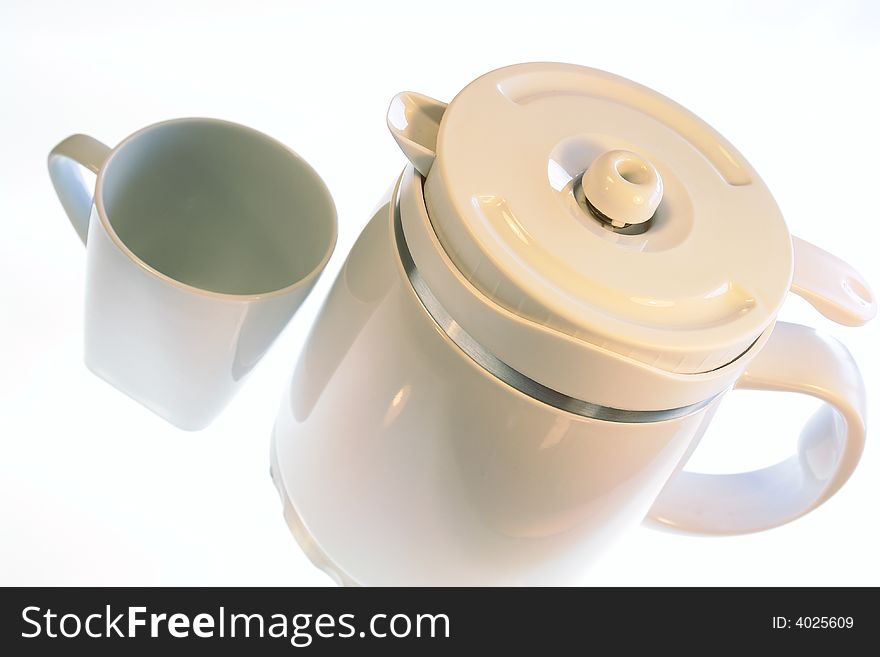 White coffee pot and mug isolated on a white background. White coffee pot and mug isolated on a white background