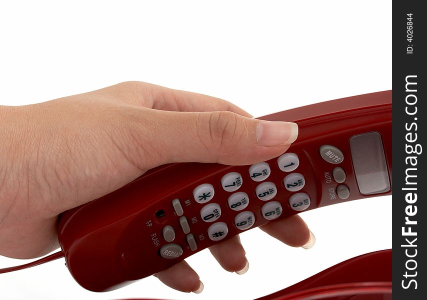 A hand picking up a phone over a white background. A hand picking up a phone over a white background