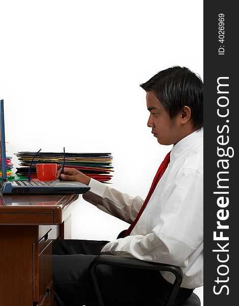 A man working on his laptop over a white background. A man working on his laptop over a white background