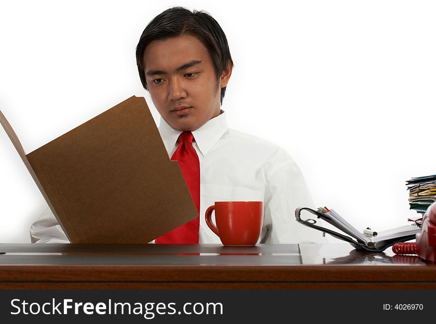 A man sitting behind an office desk. A man sitting behind an office desk