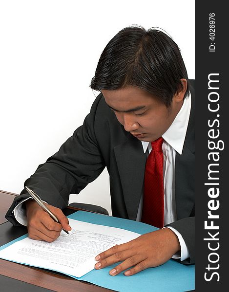 A man sitting behind his office desk. A man sitting behind his office desk