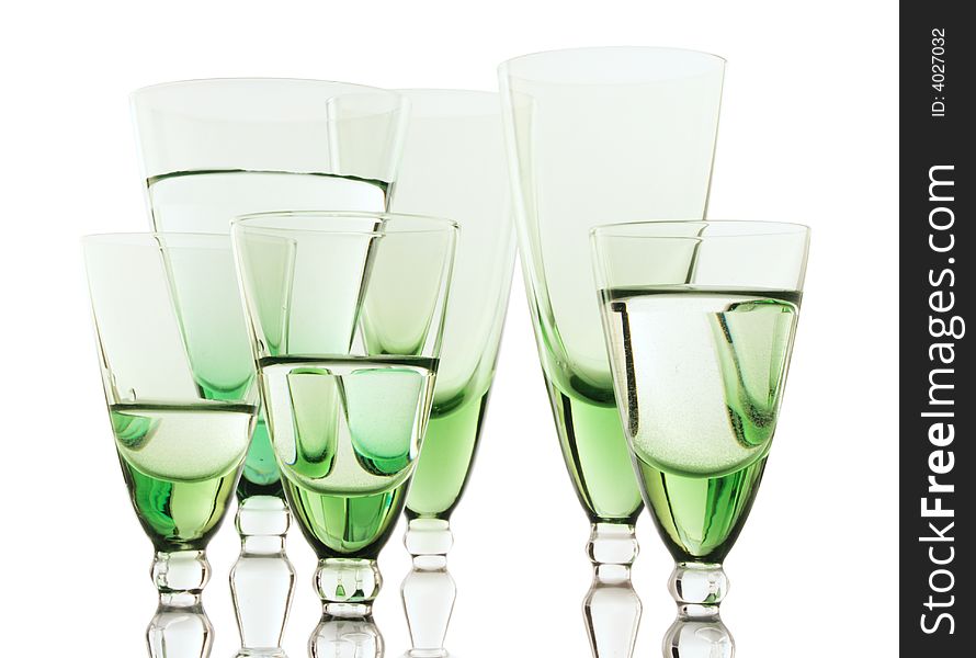 A glass beside a stack of white plates - on white background. A glass beside a stack of white plates - on white background