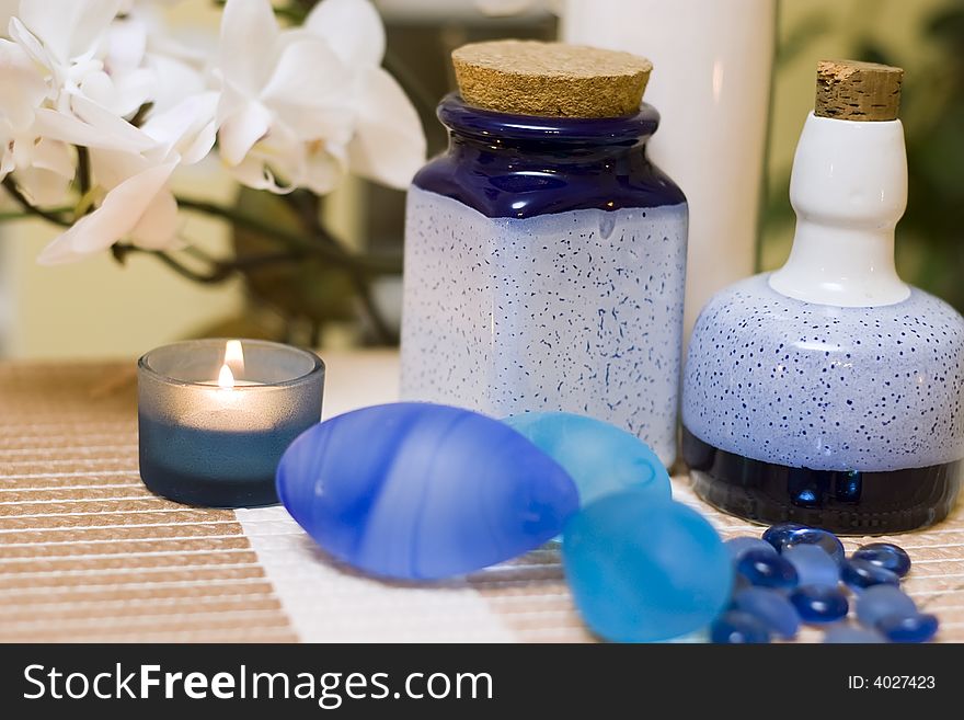 A decorative composition of blue vases and glass pebbles, orchid flower in the background. MORE SPA COMPOSITIONS ». A decorative composition of blue vases and glass pebbles, orchid flower in the background. MORE SPA COMPOSITIONS »
