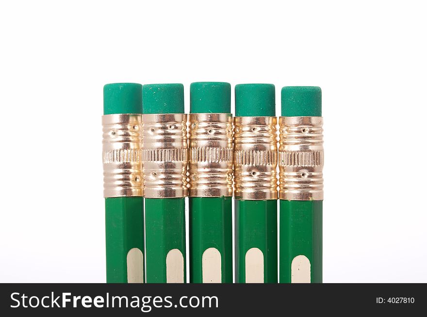 Five green pencils on a white background
