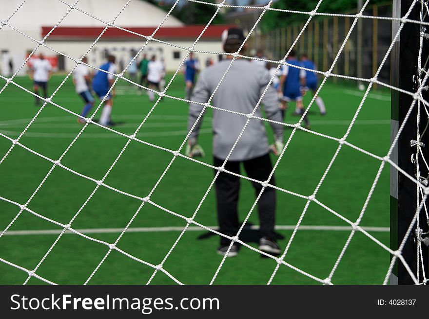 Soccer goalkeeper looking on players