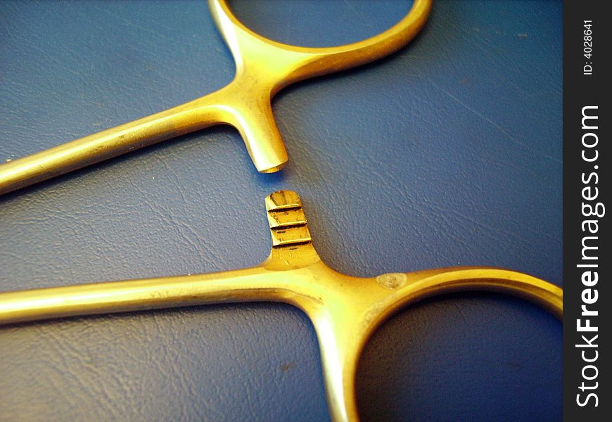 A close detail of a caliper hook on blue background