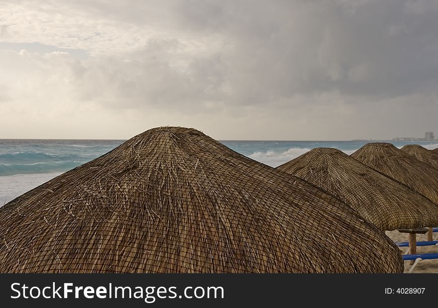 Thatched Roofs And Stormy Sky