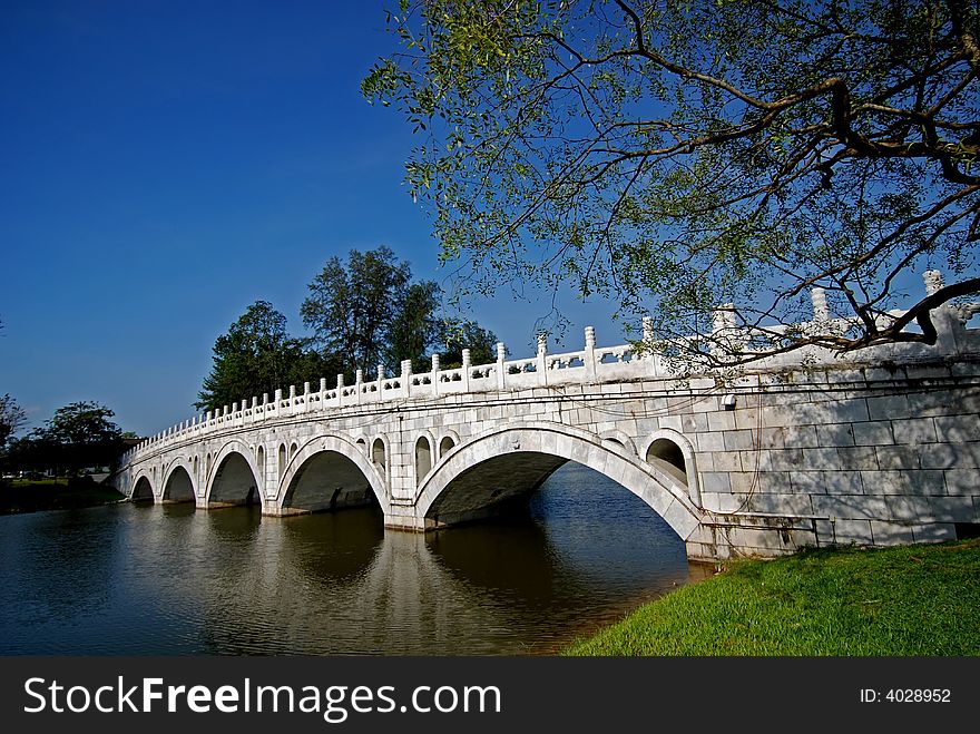 Stone bridge, tree and sky in the parks