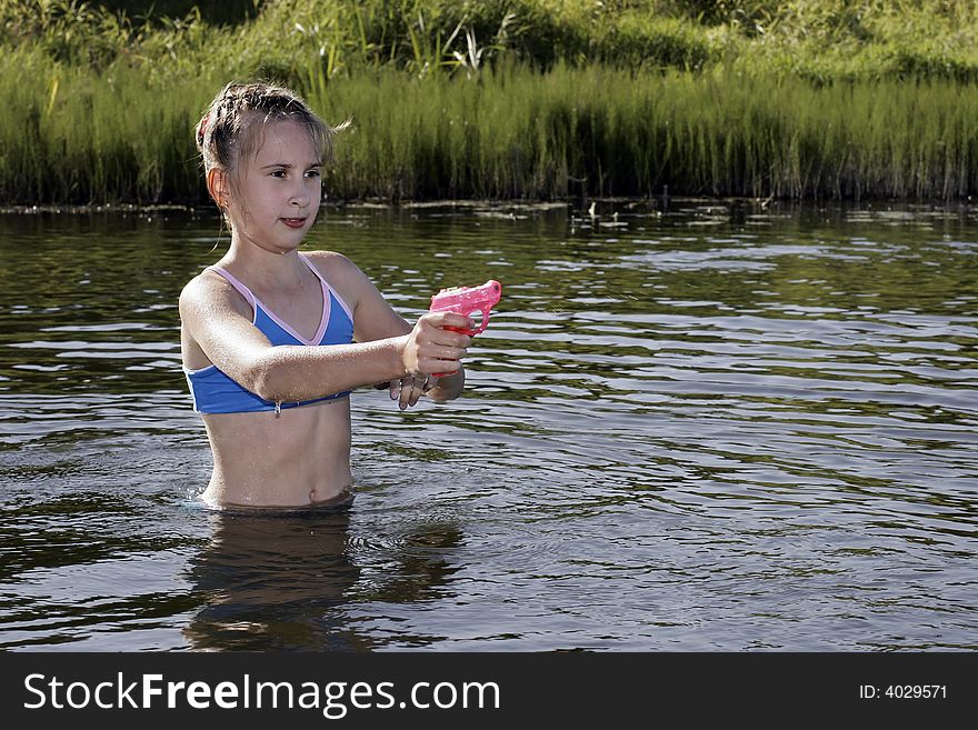 The Girl playing in running water, in river. The Girl playing in running water, in river.