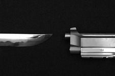 Knife And Gun Pointing Towards Each Other Royalty Free Stock Photography