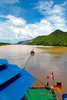 River Boat Towing Raft Down River In Asia Stock Images River Boat Towing Raft Down River In Asia Stock Images