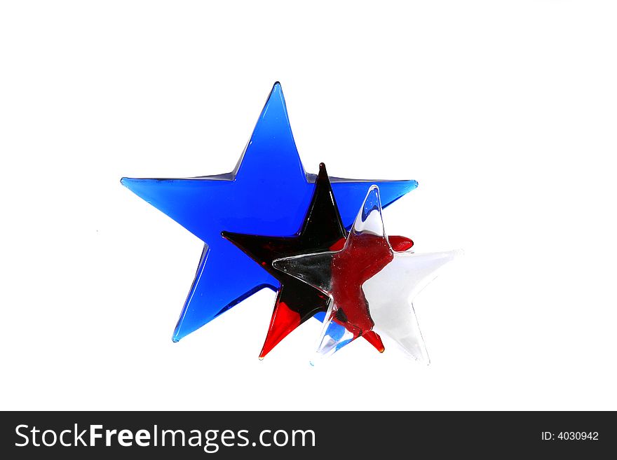 An isolated shot of a white a red and a blue star made of glass. A lot of white space for text. An isolated shot of a white a red and a blue star made of glass. A lot of white space for text.