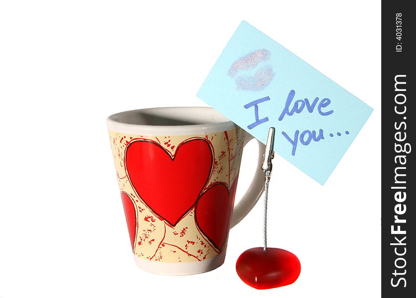 An isolated shot of a cup with hearts and an I love you note. A lot of white space for text. An isolated shot of a cup with hearts and an I love you note. A lot of white space for text.