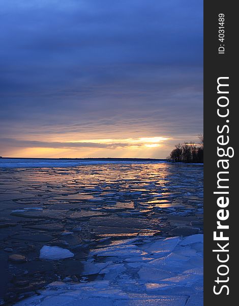 The sun sets over Three Mile Bay casting a light glow over the broken ice during a warm January thaw. The sun sets over Three Mile Bay casting a light glow over the broken ice during a warm January thaw.