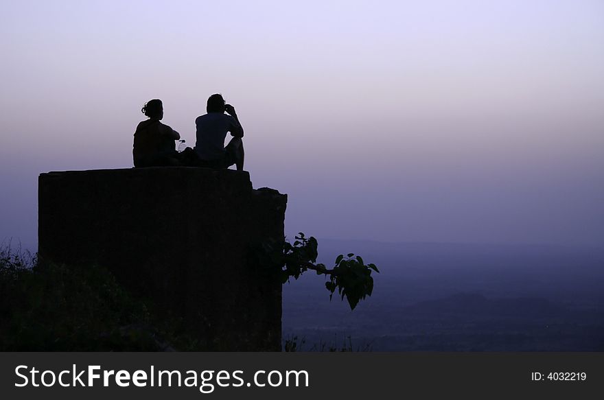 Couple chilling out on top of hill