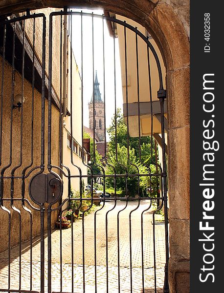 Church in Urach, Germany viewed through a wrought iron gate. Church in Urach, Germany viewed through a wrought iron gate