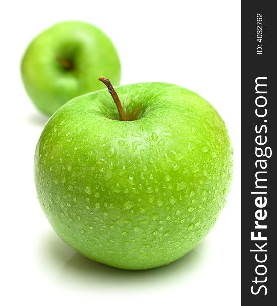 The ripe juicy apples covered by drops of water. Isolation on white, shallow DOF. The ripe juicy apples covered by drops of water. Isolation on white, shallow DOF.