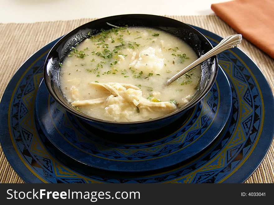 Homemade chicken (or turkey) and dumplings with crushed herbs on top