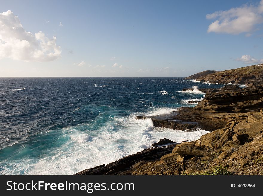 Rough seas slamming against a rocky shoreline