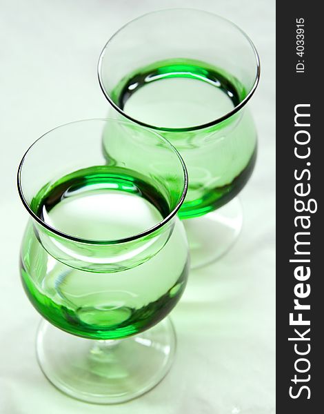 A photo of two green glasses. A photo of two green glasses