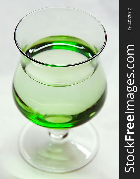 A photo of a green glass. A photo of a green glass