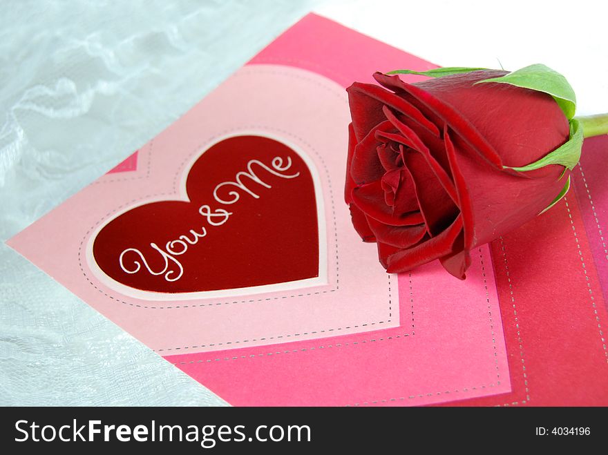 Valentine card and red rose on white lace. Valentine card and red rose on white lace.