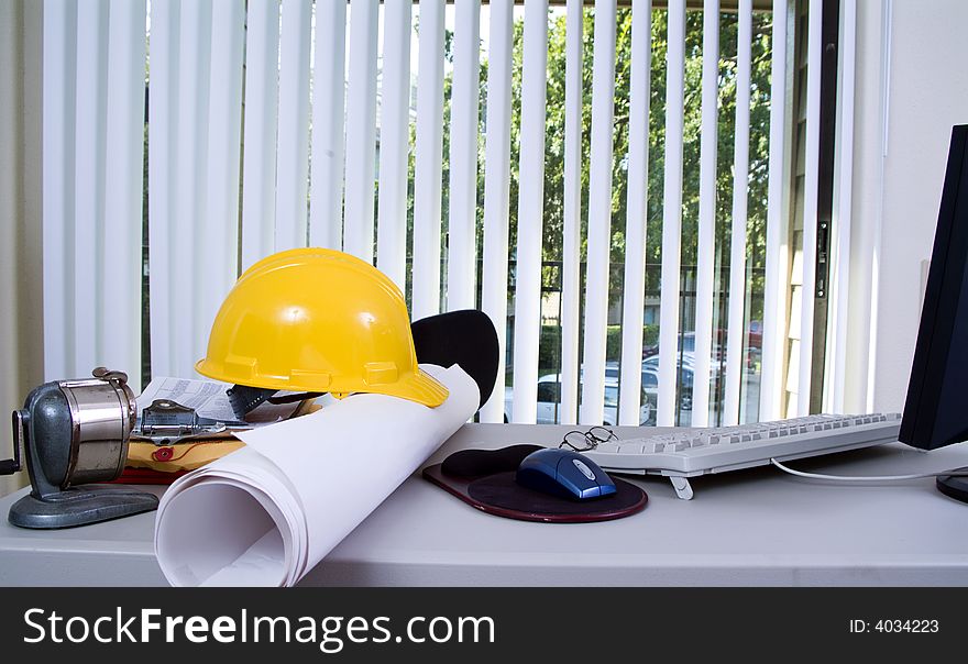 A desk cluttered with objects that indicate an engineerï¿½s or architectï¿½s office. A desk cluttered with objects that indicate an engineerï¿½s or architectï¿½s office.