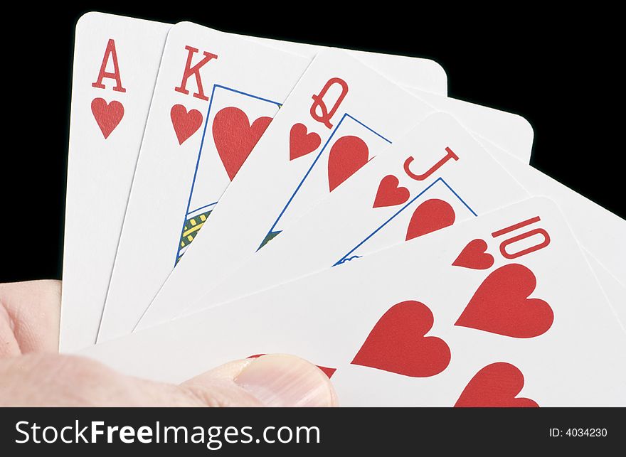 A hand holding a set of card typically known as a Royal Flush.