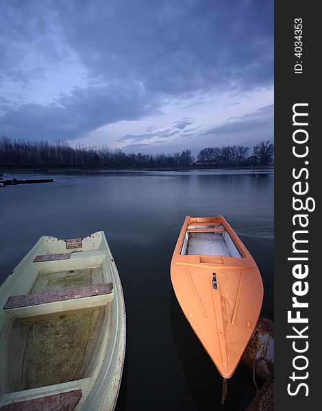 Old boat on frozen river Danube in january