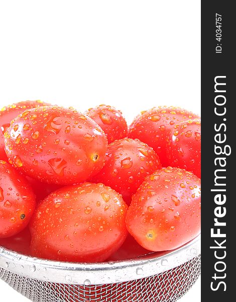 Close up of a group organic grape tomatoes in a strainer. Close up of a group organic grape tomatoes in a strainer.