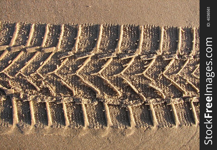 Trace of the car on the sandy beach