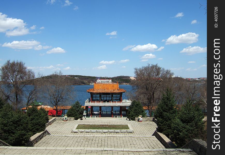 Waterfront of a lake with the blue sky and white cloud