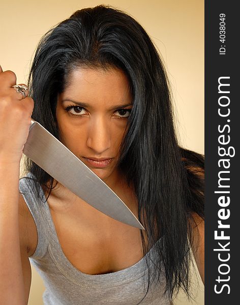 Asian woman holding large knife. Asian woman holding large knife