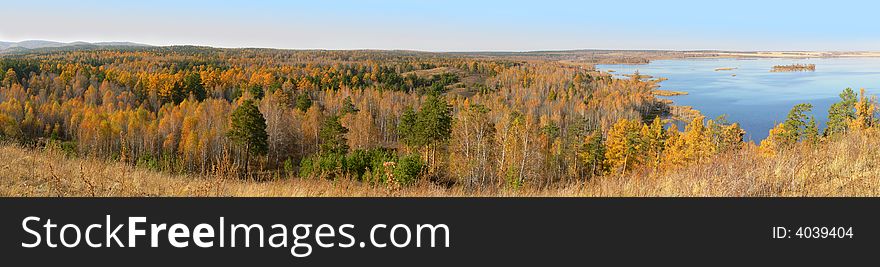 Autumn wood in the neighbourhood with lake. Panoramic view. Autumn wood in the neighbourhood with lake. Panoramic view.