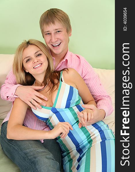 Young couple on sofa in green room