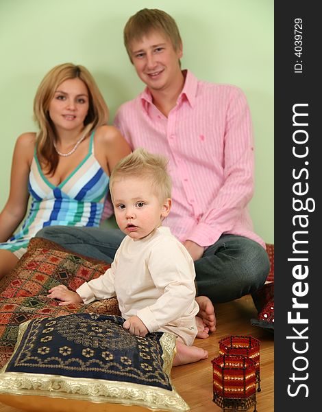 Family sit on floor on pillow 2