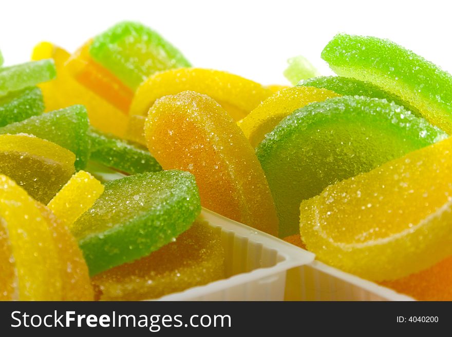 Close-up of colourful fruit candies over white