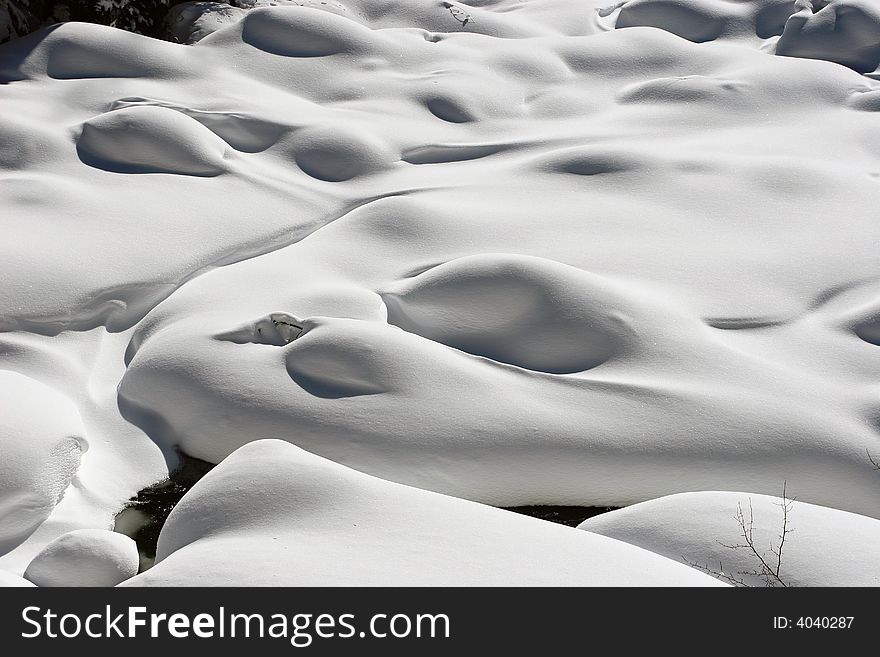 Snow mass by the creek