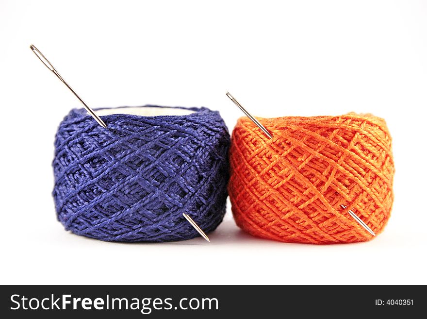 Needles and threads isolated on white background