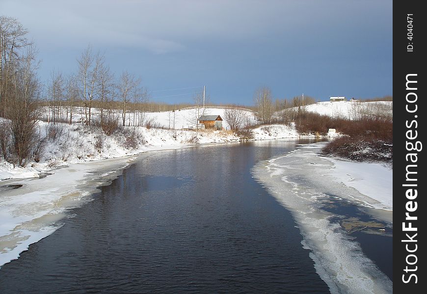 Creek waters flowing under the bridge on a cold winter's day. Creek waters flowing under the bridge on a cold winter's day.