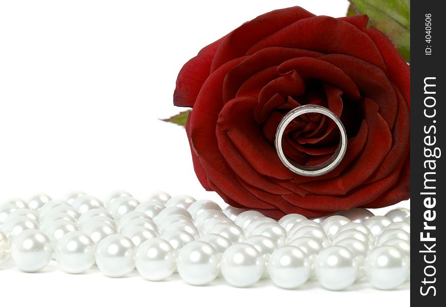 Beautiful red rose with ring lying on pearls. Beautiful red rose with ring lying on pearls