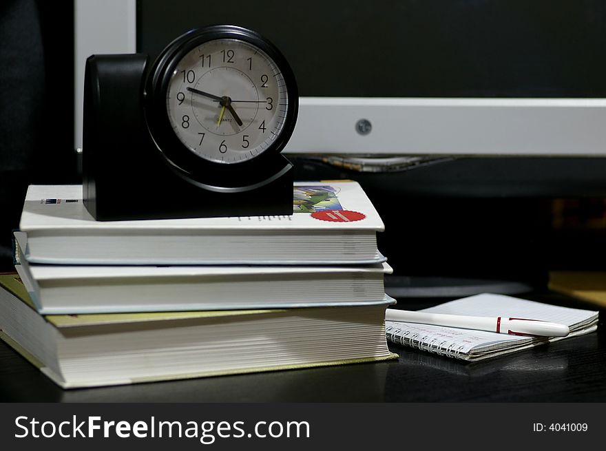 Objects on the working table: the book, hours, computer, notebook, etc. Objects on the working table: the book, hours, computer, notebook, etc.