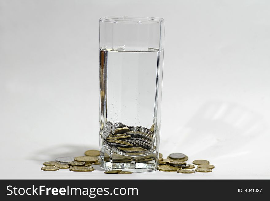 Coin in the container with the water against the white background. Coin in the container with the water against the white background