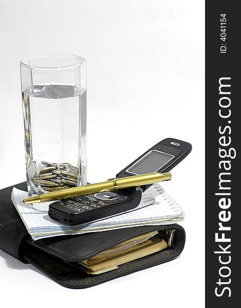 Two notebooks, knob, telephone and container with the pure water