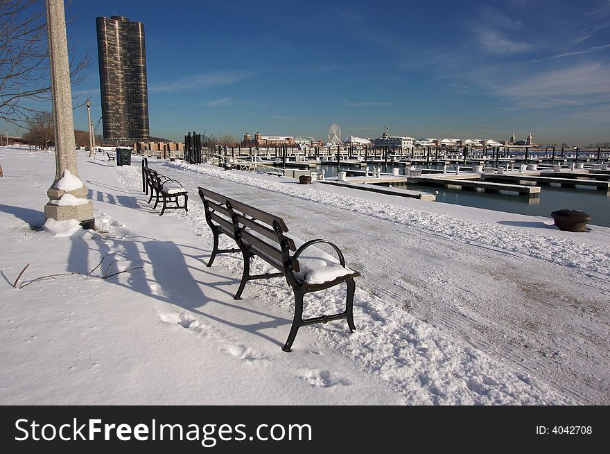 Empty Snowy Bench in Chicago After Winter Snow Along Lake Shore Drive.